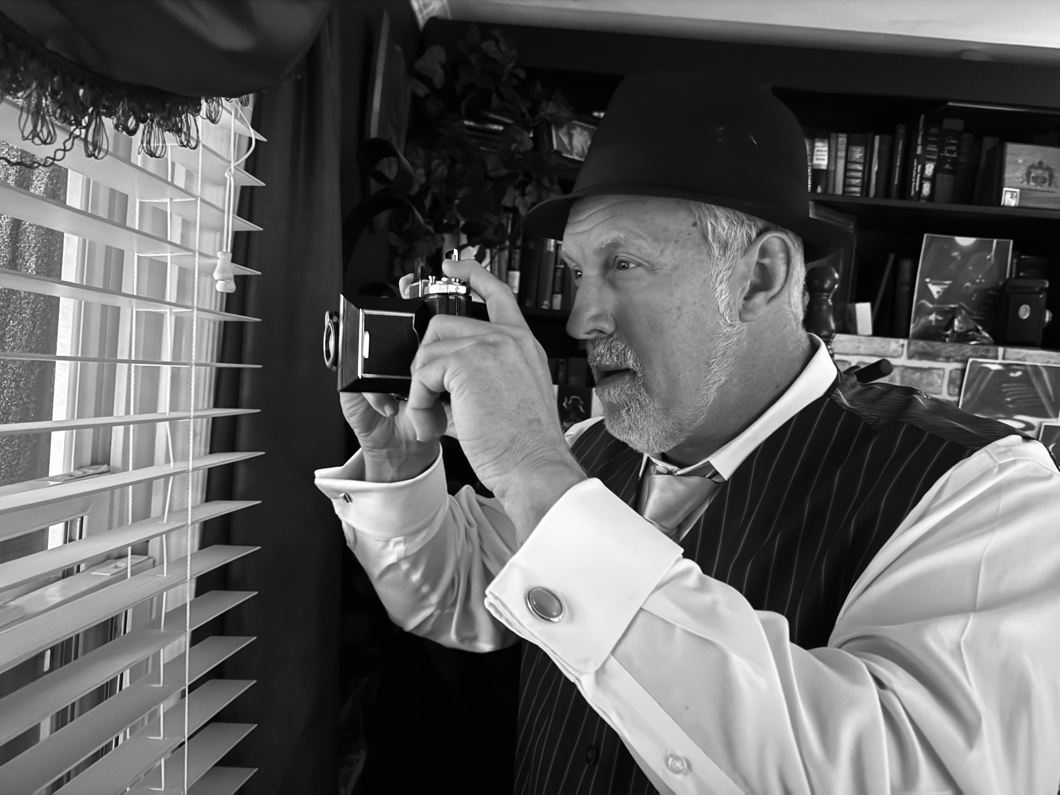 Detective Watson — Scott Watson with camera, venetian blinds, Noir Cigar™ creator Virginia Beach